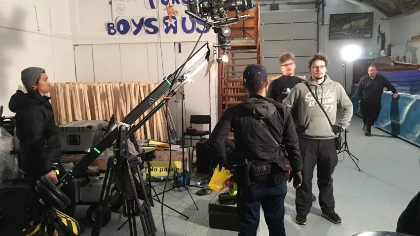 Crew stand around a camera jib on set in Shetland.